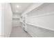 Spacious walk-in closet with white shelving and ample hanging storage provides plenty of room at 18169 E Bronco Dr, Queen Creek, AZ 85142