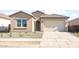 Single-story home with a tile roof, two-car garage, and low-maintenance front yard at 18169 E Bronco Dr, Queen Creek, AZ 85142