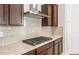 The kitchen offers a stainless steel hood, gas range cooktop and granite countertops at 18169 E Bronco Dr, Queen Creek, AZ 85142