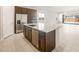 A spacious kitchen with stainless steel appliances, large island, and dark wood cabinetry at 18169 E Bronco Dr, Queen Creek, AZ 85142