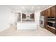 A spacious kitchen offers a large island, dark wood cabinetry and stainless steel appliances at 18169 E Bronco Dr, Queen Creek, AZ 85142