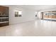 A modern living room space with oversized sliding glass doors and neutral tile flooring at 18169 E Bronco Dr, Queen Creek, AZ 85142