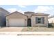 Charming single-story home with a two-car garage, desert landscaping, and a stylish front door at 18180 E Tiffany Dr, Queen Creek, AZ 85142