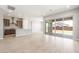 Open-concept living room with tile flooring, large sliding doors, and view of modern kitchen at 18180 E Tiffany Dr, Queen Creek, AZ 85142