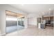 Open-concept living area features tile flooring, large sliding doors to backyard, and kitchen at 18180 E Tiffany Dr, Queen Creek, AZ 85142