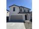 Charming two-story home with a neutral color scheme and a spacious two car garage in front at 1963 E Harness Ln, San Tan Valley, AZ 85140