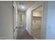 Hallway with carpet, doors to bedrooms and laundry room at 1963 E Harness Ln, San Tan Valley, AZ 85140