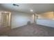 Upstairs loft area with gray carpet and multiple doors at 1963 E Harness Ln, San Tan Valley, AZ 85140