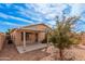 Backyard featuring a covered patio, mature trees, and neutral stucco exterior at 19850 N 110Th Ln, Peoria, AZ 85373