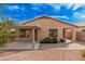 Backyard featuring red rock landscaping, covered patio, privacy shrubs and a walkway at 19850 N 110Th Ln, Peoria, AZ 85373