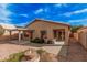 Backyard with red rock landscaping, covered patio, walkway and a decorative water feature at 19850 N 110Th Ln, Peoria, AZ 85373