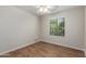 Bedroom featuring hardwood floors, a ceiling fan, and a window that provides natural light at 19850 N 110Th Ln, Peoria, AZ 85373