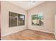 Cozy bedroom with neutral walls, wood floors, and bright windows at 19850 N 110Th Ln, Peoria, AZ 85373