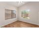 Bright bedroom showcasing dual windows offering natural light and wood flooring at 19850 N 110Th Ln, Peoria, AZ 85373