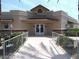 Community clubhouse with decorative landscaping, tiled roof, and covered entryway at 19850 N 110Th Ln, Peoria, AZ 85373