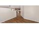 Hallway leading to the kitchen, featuring wood flooring and neutral wall colors at 19850 N 110Th Ln, Peoria, AZ 85373