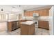 Bright kitchen features light wood cabinets, stainless steel appliances, and a central island at 19850 N 110Th Ln, Peoria, AZ 85373