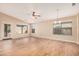 Spacious living room features laminated wood floors, large windows and modern ceiling fan at 19850 N 110Th Ln, Peoria, AZ 85373