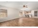 Spacious living room with hardwood floors offers an open layout and access to the modern kitchen at 19850 N 110Th Ln, Peoria, AZ 85373