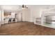 Open living area with wood floors, built-in shelving, and seamlessly connected to a well-appointed kitchen at 19850 N 110Th Ln, Peoria, AZ 85373