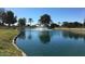 Scenic community pond featuring lush landscaping and fountain at 19850 N 110Th Ln, Peoria, AZ 85373