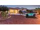 Outdoor living space with covered patio and inviting pool at twilight at 20914 W Cora Vis, Buckeye, AZ 85396