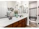Bathroom with a dual sink vanity, decorative mirrors and accents, and a shower-tub combination offering functionality at 20914 W Cora Vis, Buckeye, AZ 85396