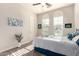 Bright bedroom featuring arched windows, neutral walls, and stylish decor, creating a serene retreat at 20914 W Cora Vis, Buckeye, AZ 85396