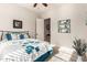 Comfortable bedroom with a stylish blue-themed bed set, carpeted floor and neutral wall color, adding a cozy touch at 20914 W Cora Vis, Buckeye, AZ 85396