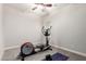 Bright exercise room equipped with an elliptical machine, yoga mat, and weights, promoting a healthy lifestyle at 20914 W Cora Vis, Buckeye, AZ 85396