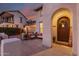 Inviting front entrance with a cozy seating area, 'Welcome' sign, and beautiful sunset skies at 20914 W Cora Vis, Buckeye, AZ 85396