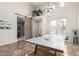 Bright game room features a ping pong table, high ceilings, and barn door at 20914 W Cora Vis, Buckeye, AZ 85396