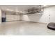 Spacious garage with epoxy flooring, ample storage shelves, and a functional layout, ideal for parking and projects at 20914 W Cora Vis, Buckeye, AZ 85396