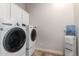 Laundry room with modern washer and dryer, plus water dispenser and additional storage solutions at 20914 W Cora Vis, Buckeye, AZ 85396