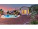 Beautiful backyard pool area with desert landscaping and evening illumination at 20914 W Cora Vis, Buckeye, AZ 85396
