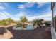 Inviting backyard pool area features a lounge area, desert landscaping, and a wrought iron fence at 20914 W Cora Vis, Buckeye, AZ 85396