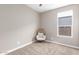 Small bedroom with wicker chair and large window at 2462 N Wrigley Dr, Florence, AZ 85132