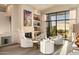 Living room with fireplace, built-ins, and scenic view at 24652 N 111Th Pl, Scottsdale, AZ 85255