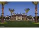 Elegant community clubhouse with palm trees and a spacious lawn at 26021 N 23Rd Ave, Phoenix, AZ 85085