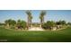 A grand entrance to a community, featuring palm trees and manicured lawns at 26021 N 23Rd Ave, Phoenix, AZ 85085