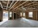 Unfinished interior with exposed framing, multiple windows, and visible ductwork and plumbing lines, awaiting customization at 26021 N 23Rd Ave, Phoenix, AZ 85085