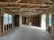 Unfinished interior showcasing wall studs, window placements, and open layout ready for customization and finishing touches at 26021 N 23Rd Ave, Phoenix, AZ 85085
