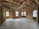 Spacious unfinished interior with exposed beams, rough-in wiring, and multiple windows for abundant natural light at 26021 N 23Rd Ave, Phoenix, AZ 85085