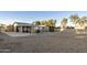Large backyard with gravel and a covered patio at 26622 S Beech Creek Dr, Sun Lakes, AZ 85248