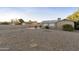 Large backyard with gravel and a covered patio at 26622 S Beech Creek Dr, Sun Lakes, AZ 85248