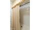 Bathroom with wallpaper, white tiled shower, shower curtain and beige tile floor at 26622 S Beech Creek Dr, Sun Lakes, AZ 85248