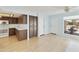 Bright, open floor plan showing the kitchen and dining area with light-colored wood flooring at 26622 S Beech Creek Dr, Sun Lakes, AZ 85248