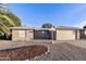 Tan house with a two-car garage and landscaped front yard at 26622 S Beech Creek Dr, Sun Lakes, AZ 85248