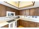 White appliances and wood cabinets in this kitchen at 26622 S Beech Creek Dr, Sun Lakes, AZ 85248