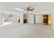 Spacious living area showcasing neutral tones, chandelier, and seamless flow to the outdoor patio at 26622 S Beech Creek Dr, Sun Lakes, AZ 85248